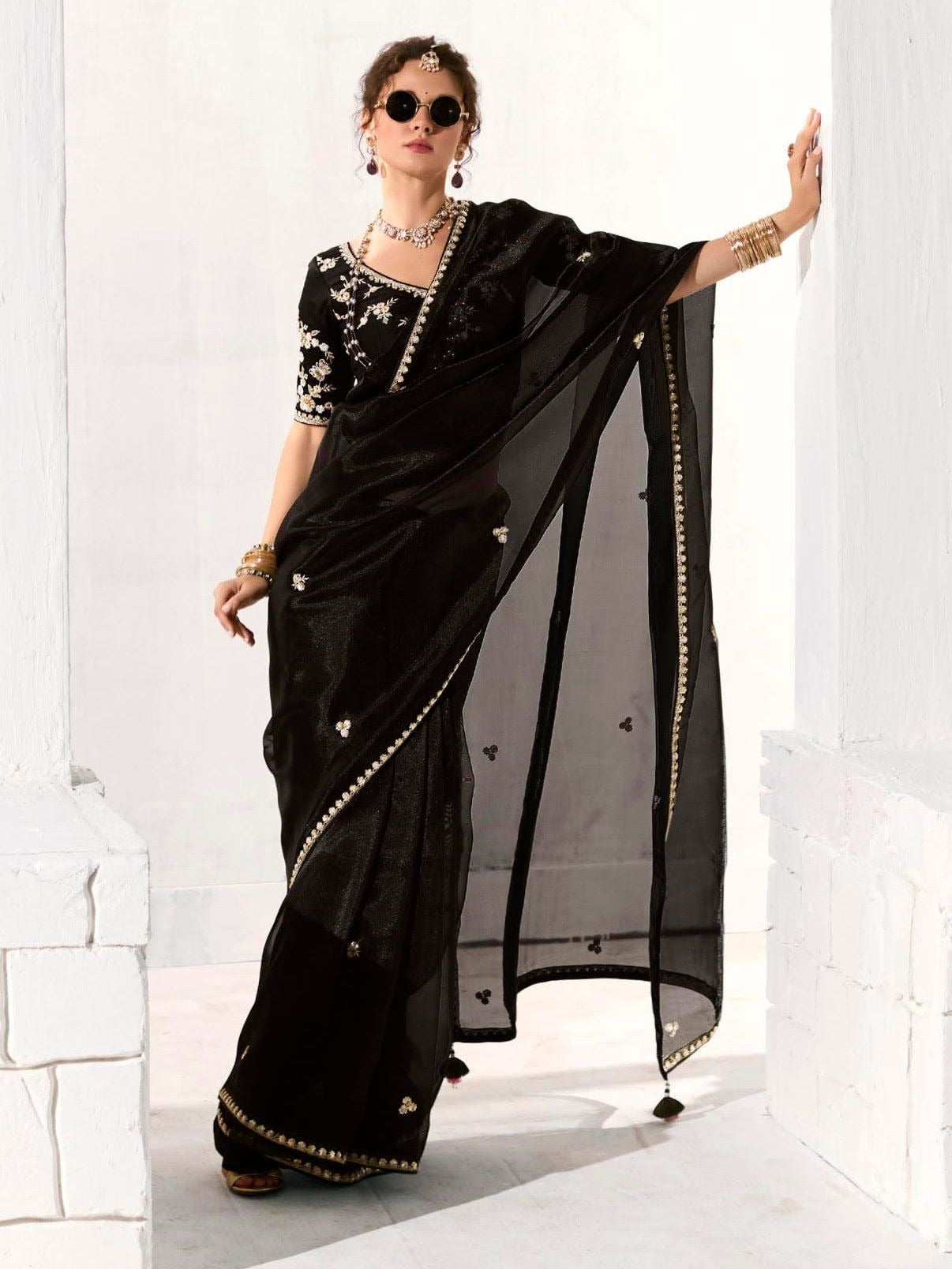 Dhiyona KM Women Royal Black Organza Saree With Black Embroidered Blouse “ A Symphony Of Power And Grace Meta Description: