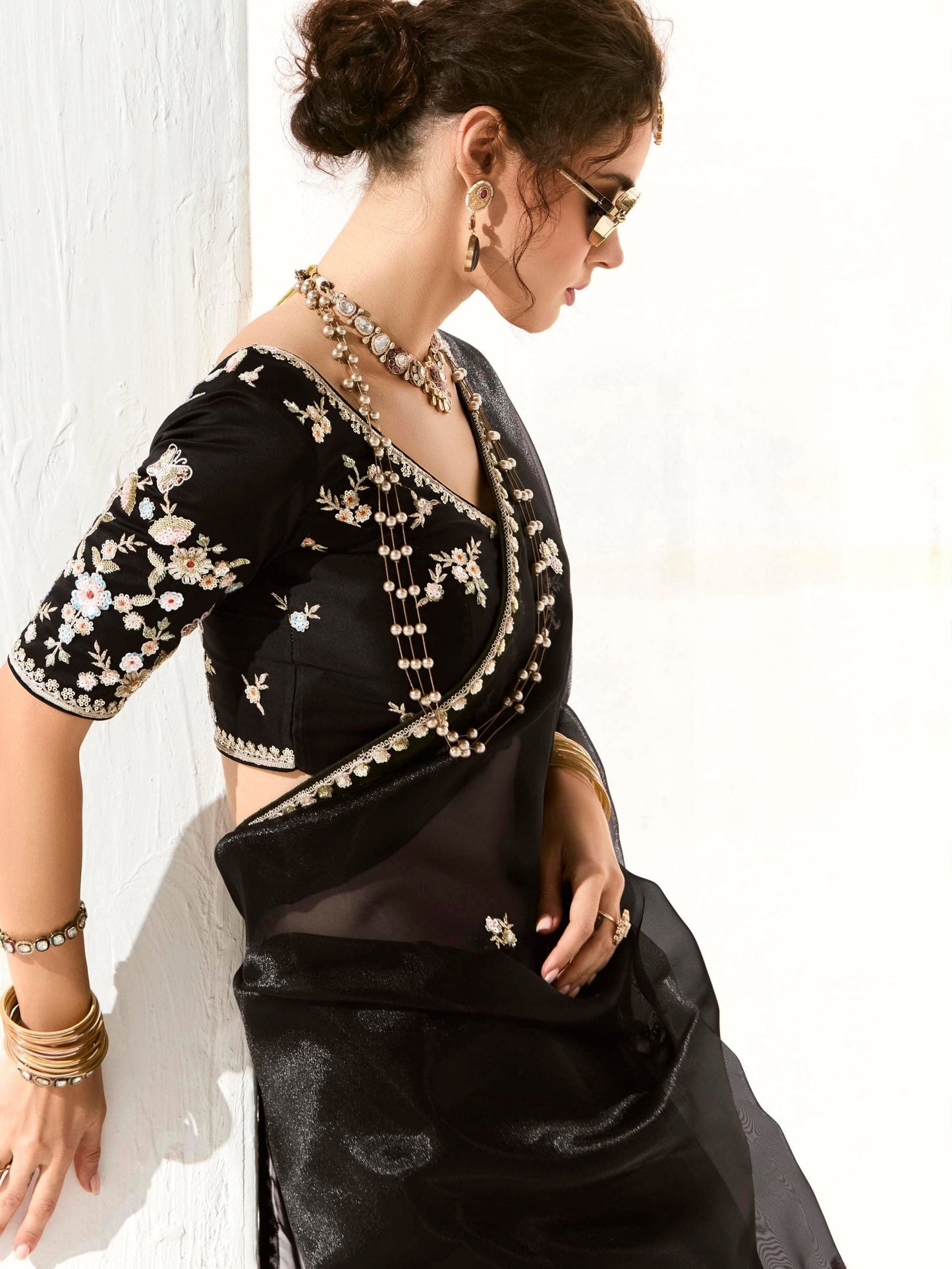 Dhiyona KM Women Royal Black Organza Saree With Black Embroidered Blouse “ A Symphony Of Power And Grace Meta Description: