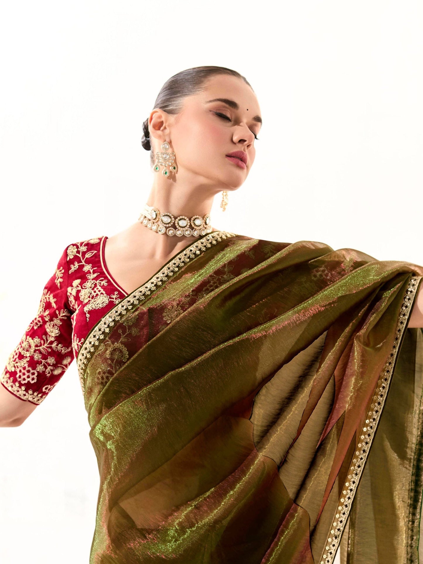 Dhiyona KM Women Mahendi Green Tissue Silk Saree With Red Blouse “ Inspired By Tradition & Bold Elegancemahendi Green Tissue Silk Saree With Red Blouse