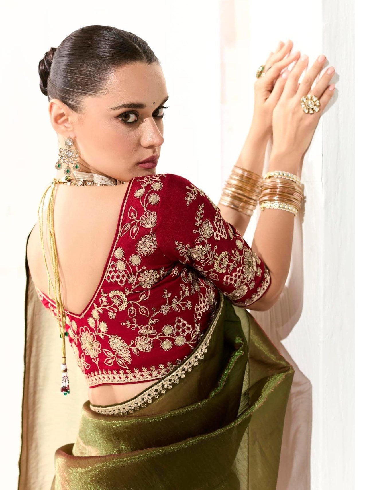 Dhiyona KM Women Mahendi Green Tissue Silk Saree With Red Blouse “ Inspired By Tradition & Bold Elegancemahendi Green Tissue Silk Saree With Red Blouse