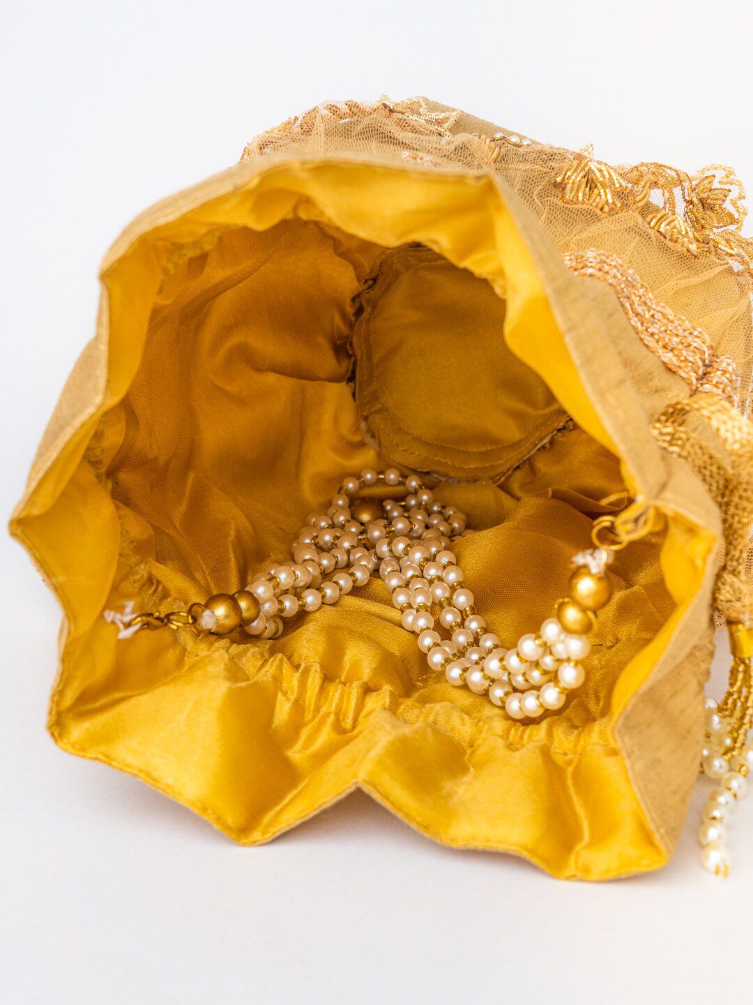 Dhiyona NR Gold-Toned & White Embellished Tasselled Potli Clutch