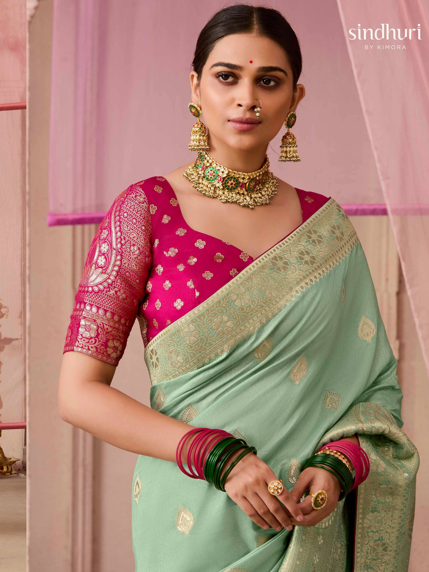 Dhiyona KM Women Sea Green Dola Silk Saree With Red Golden Embroidered Blouse