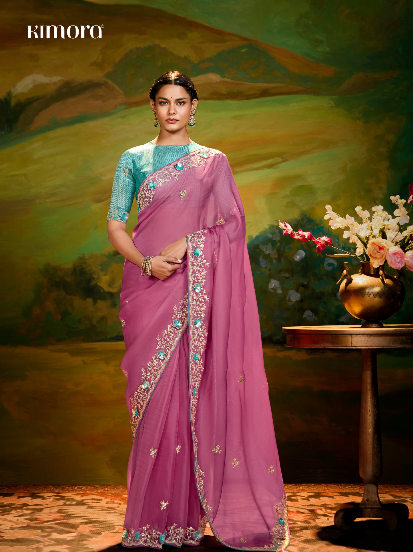 Dhiyona KM Women The Pink Silk Saree With Teal Blouse