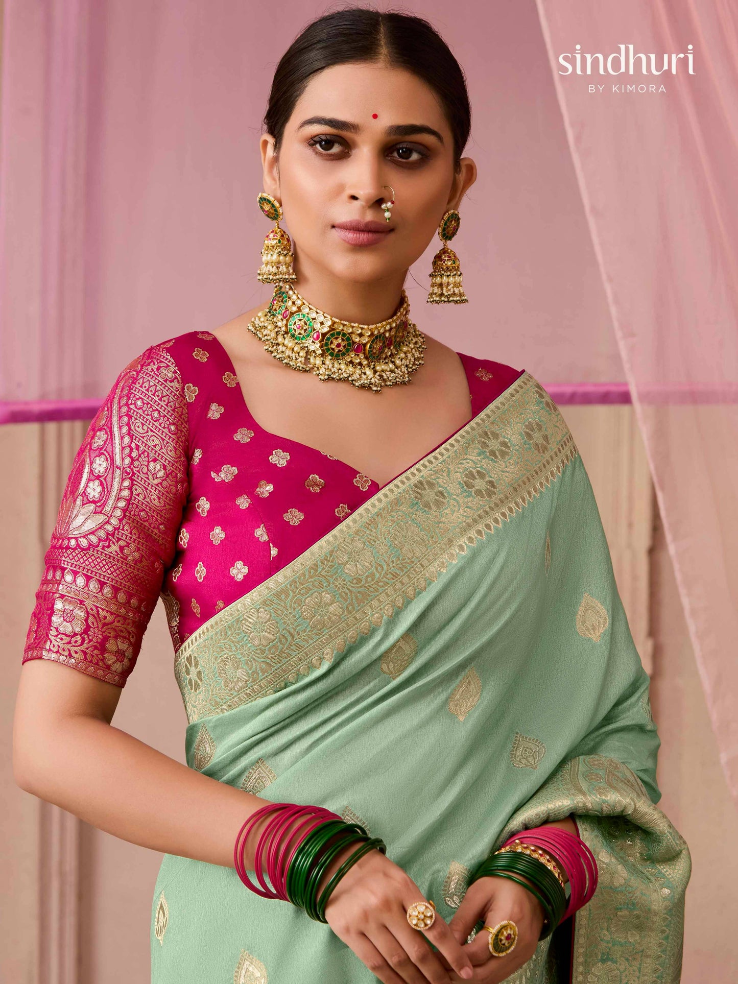 Dhiyona KM Women Sea Green Dola Silk Saree With Red Golden Embroidered Blouse