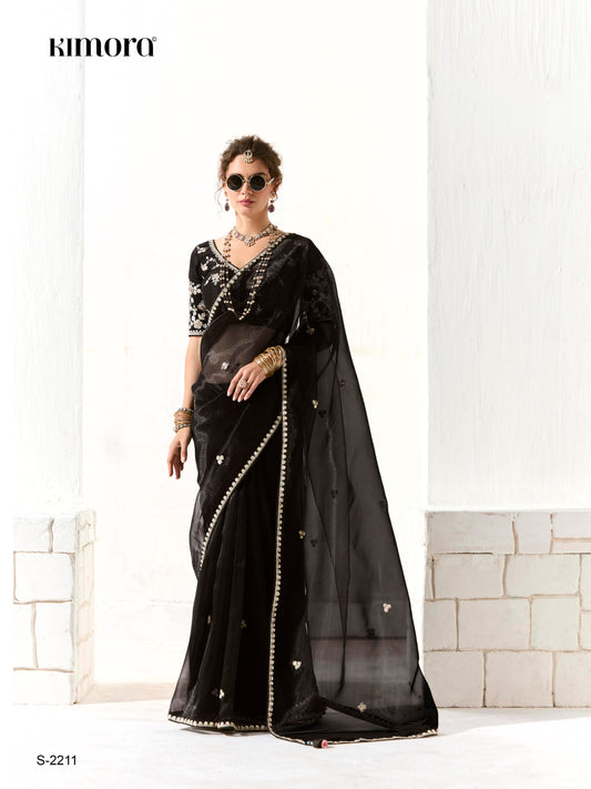 Dhiyona KM Women Royal Black Organza Saree With Black Embroidered Blouse “ A Symphony Of Power And Grace  Meta Description:
