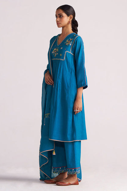 Woman wearing a Celestial Blue Embroidered Kurta Set outfit on a light gray background