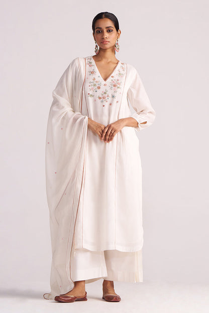 Woman wearing a Ivory Embroidered Kurta Set with a plain background
