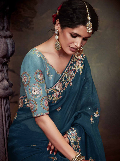 Dhiyona KM Women Teal Blue Designer Organza Silk Saree With Heavy Embroidered Floral Border And Contrast Blouse