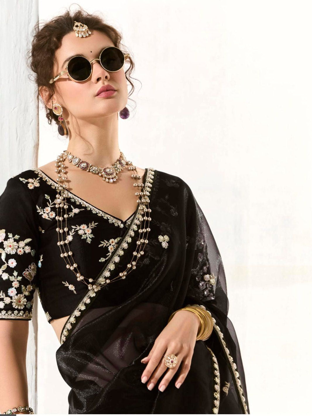 Dhiyona KM Women Royal Black Organza Saree With Black Embroidered Blouse “ A Symphony Of Power And Grace  Meta Description: