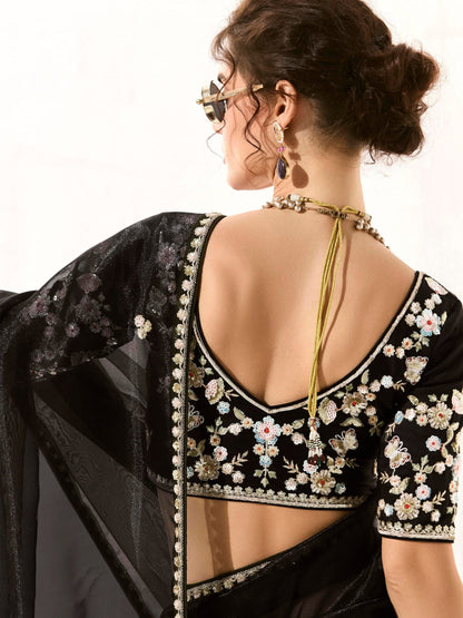 Dhiyona KM Women Royal Black Organza Saree With Black Embroidered Blouse “ A Symphony Of Power And Grace  Meta Description: