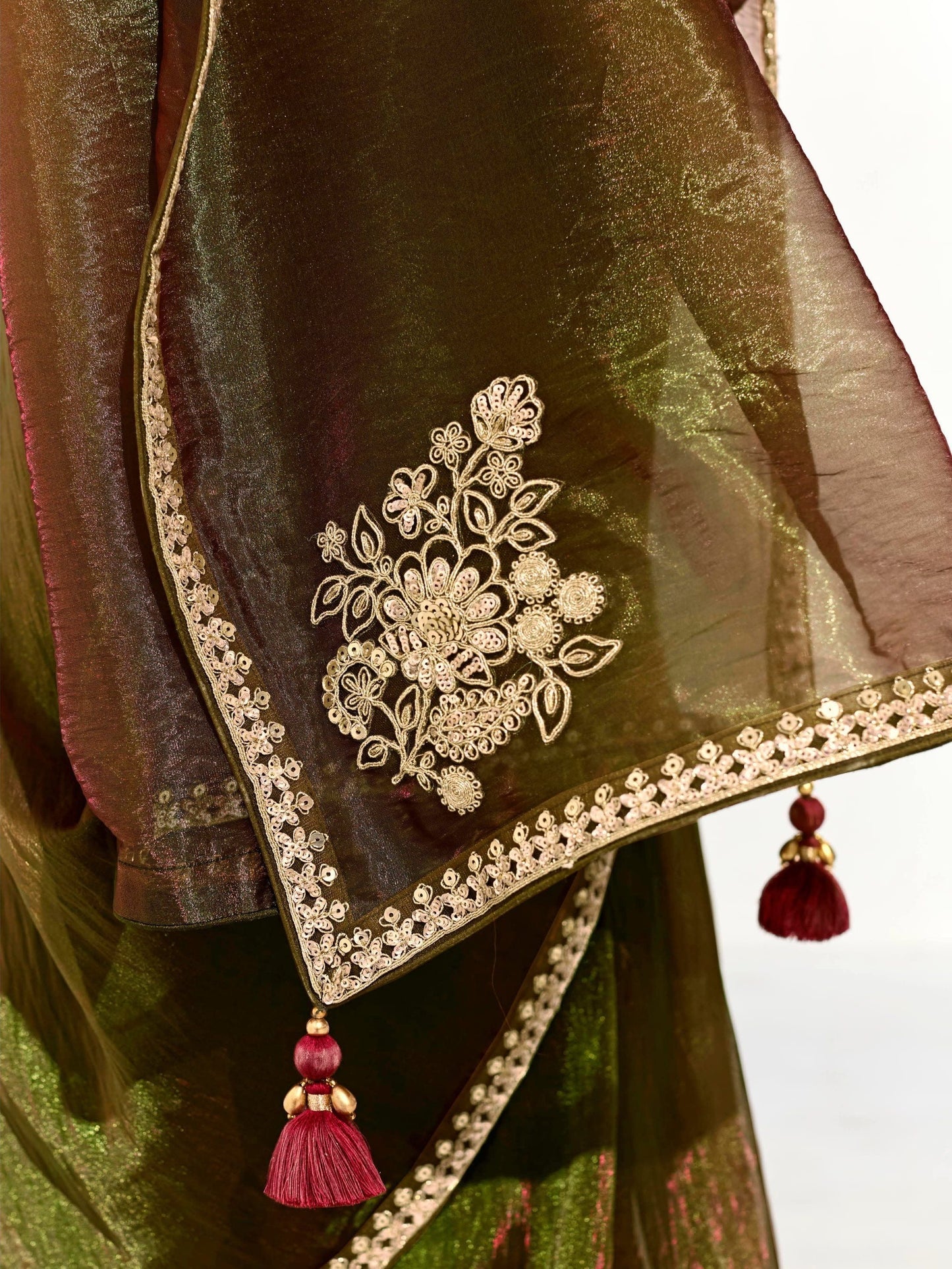 Dhiyona KM Women Mahendi Green Tissue Silk Saree With Red Blouse “ Inspired By Tradition & Bold Elegancemahendi Green Tissue Silk Saree With Red Blouse
