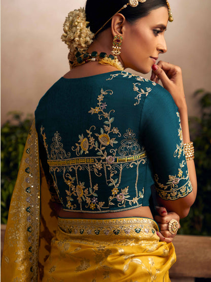 Dhiyona KM Women Vibrant Yellow Silk Saree With Teal Embroidered Blouse