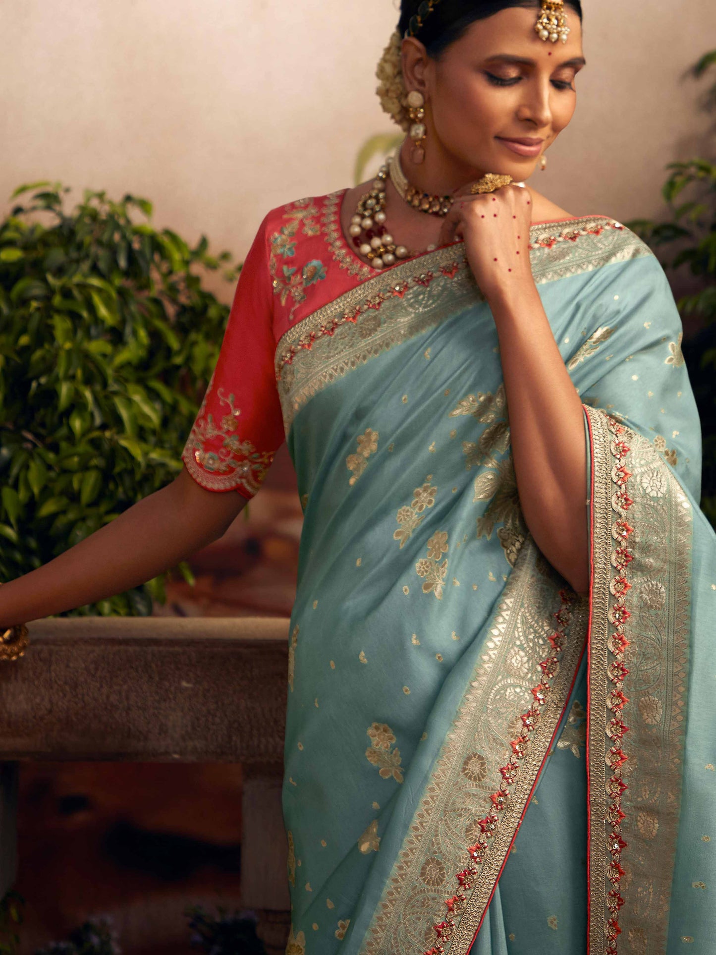 Dhiyona KM Women Light Blue Silk Zari Weaved Saree With Broad Border & Red Embroidered Blouse