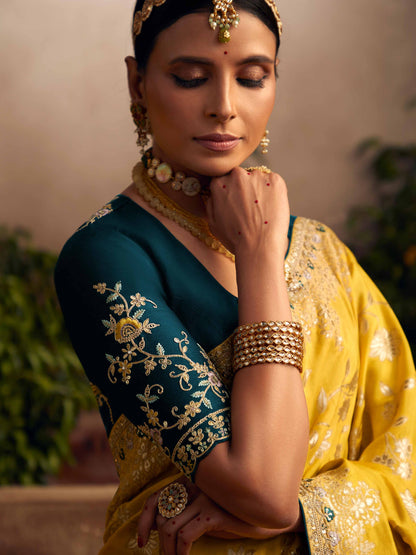Dhiyona KM Women Vibrant Yellow Silk Saree With Teal Embroidered Blouse