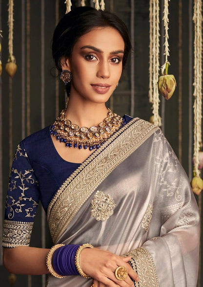 Dhiyona KM Women Soft Tissue Silk Saree With Intricate Silver Embroidery & Contrast Blue Blouse