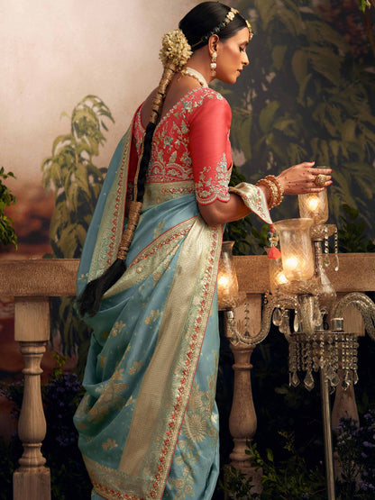 Dhiyona KM Women Light Blue Silk Zari Weaved Saree With Broad Border & Red Embroidered Blouse