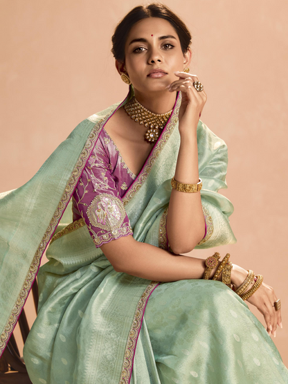 Dhiyona KM Women Mint Green Kanjivaram Silk Saree With Elegant Purple Embroidered Blouse “ A Dreamy Delight